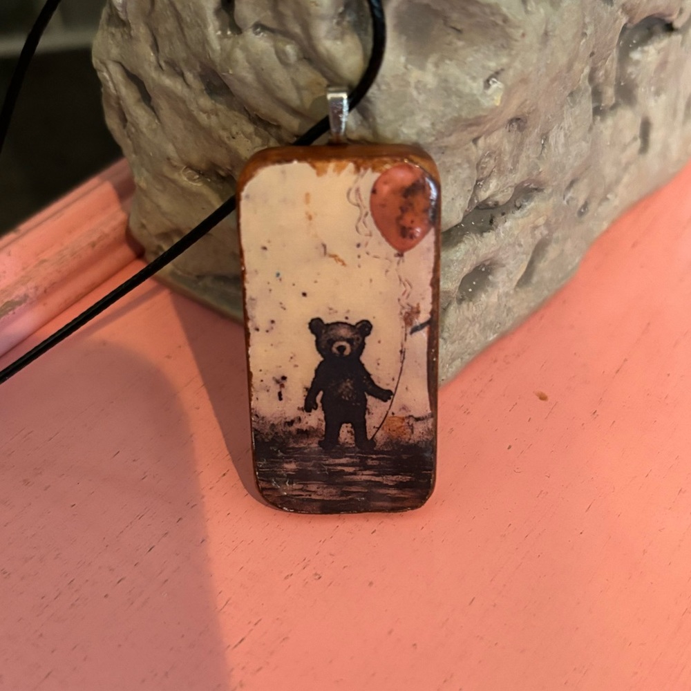 Vintage teddy bear holding red ballon pendant